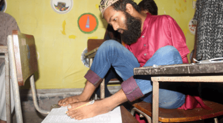 দুই হাত নেই, পা দিয়ে লিখে ভর্তি পরীক্ষা দিলেন রাজবাড়ীর হাবিবুর